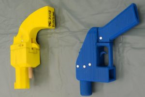 Seized plastic handguns which were created using 3D printing technology are displayed at Kanagawa police station in Yokohama, south of Tokyo, in this photo taken by Kyodo May 8, 2014. Yoshimoto Imura became the first man to be arrested in Japan for illegal possession of two guns he created himself using 3D printing technology, Japanese media said on Thursday. The 27-year-old, a college employee in the city of Kawasaki, was arrested after police found video online posted by Imura claiming to have produced his own guns. Gun possession is strictly regulated in Japan. Police raided Imura's home and found five guns, two of which could fire real bullets, Japanese media said. Mandatory credit REUTERS/Kyodo (JAPAN - Tags: CRIME LAW SCIENCE TECHNOLOGY) ATTENTION EDITORS - THIS IMAGE HAS BEEN SUPPLIED BY A THIRD PARTY. FOR EDITORIAL USE ONLY. NOT FOR SALE FOR MARKETING OR ADVERTISING CAMPAIGNS. MANDATORY CREDIT. JAPAN OUT. NO COMMERCIAL OR EDITORIAL SALES IN JAPAN. THIS PICTURE IS DISTRIBUTED EXACTLY AS RECEIVED BY REUTERS, AS A SERVICE TO CLIENTS