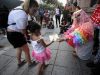 A participant dressed in drag gives a book to a child during the "Drag Queen Story Hour" event in downtown Monterrey, Mexico. June 9, 2019. REUTERS/Daniel Becerril.