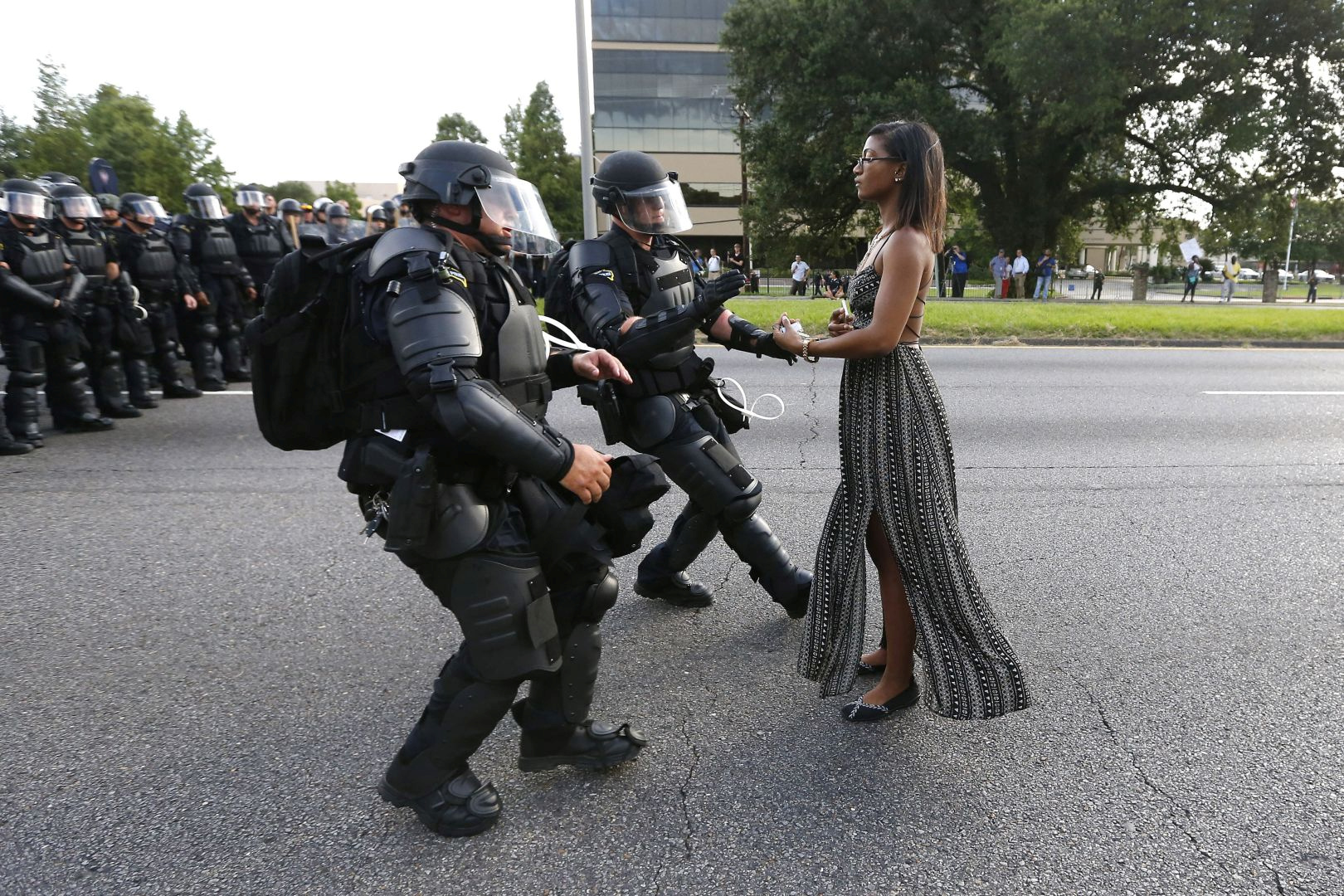 Lone activist Ieshia Evans stands her ground while offering her hands for arrest as she is charged by riot police during a protest against police brutality outside the Baton Rouge Police Department in Louisiana