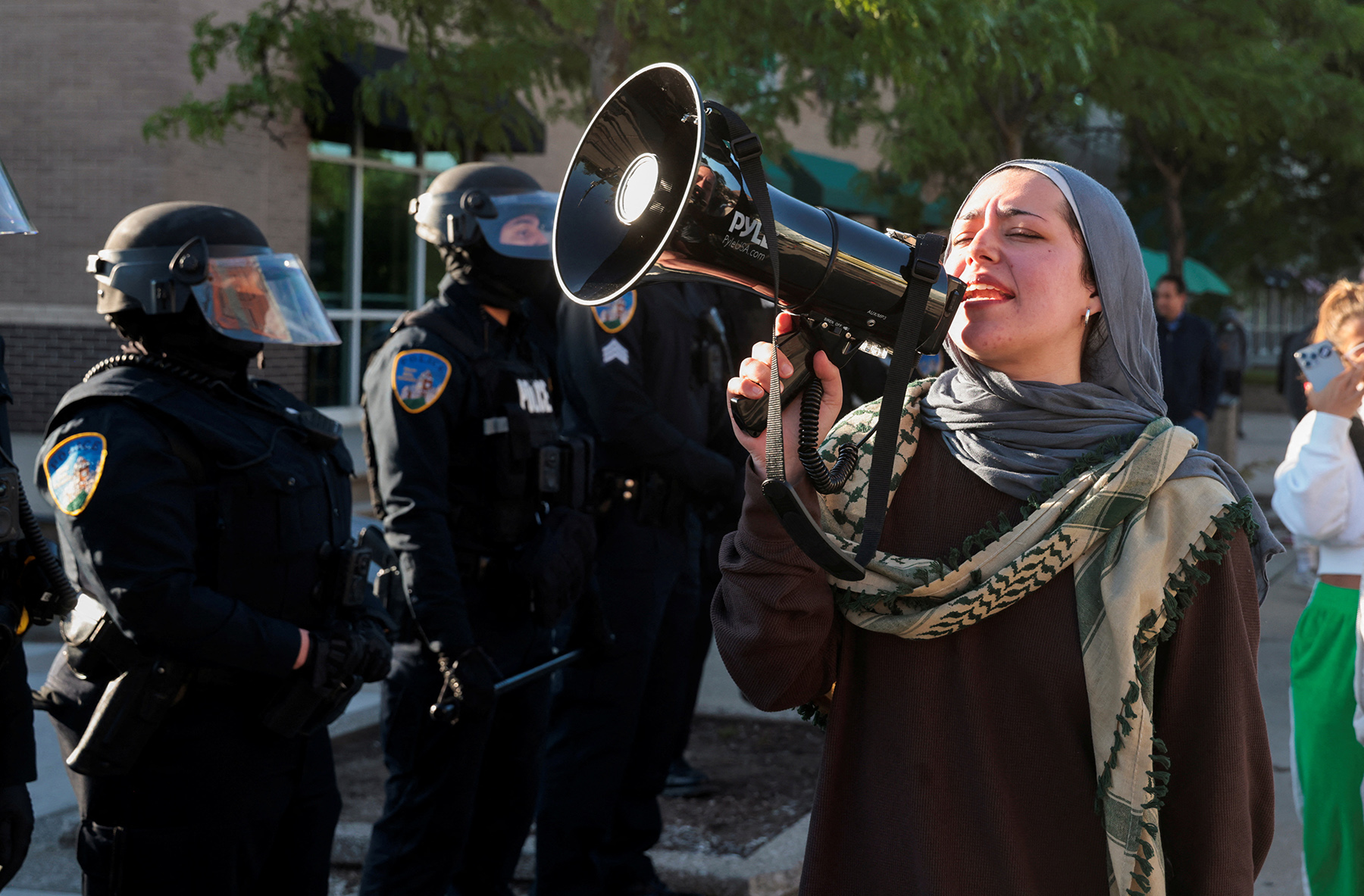 A pro-Palestinnian demonstrator protests after the Wayne State University police raided the WSU student encampment in Detroit