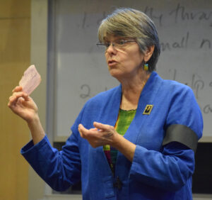 Mary Beth Tinker holding her original detention slip after she wore a black armband to school to protest the Vietnam War (with a replica on her left arm) during a speech