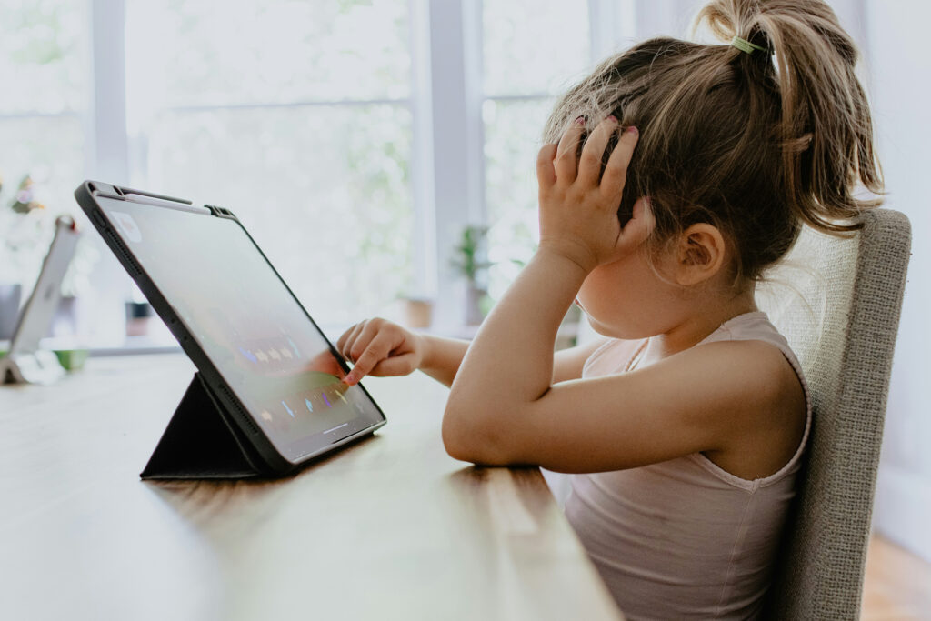 Young girl practicing kids coding on iPad