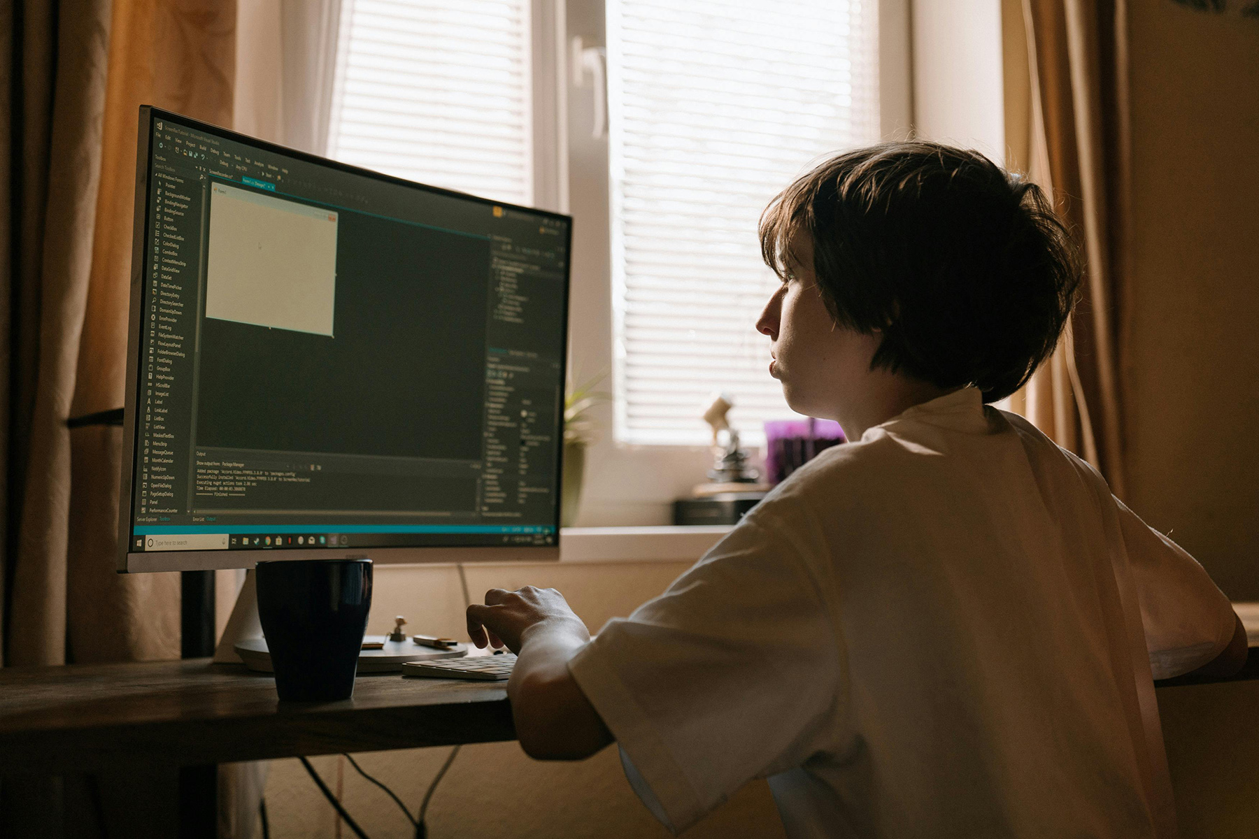 Boy in White Long Sleeve Shirt Playing Computer Game