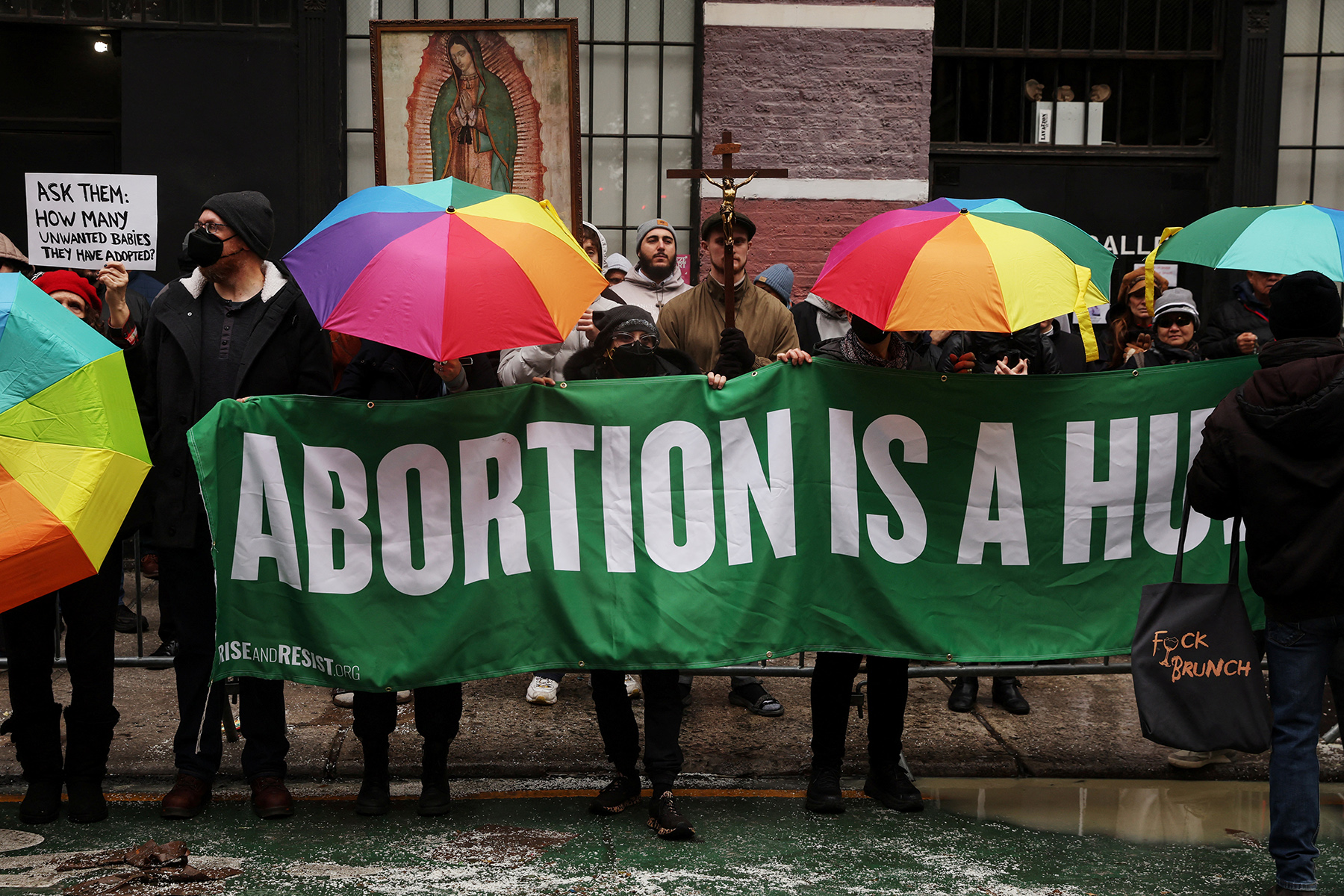 Abortion rights activists stand in front of anti-abortion activists as they pray outside the Planned Parenthood Manhattan Health Center in New York City