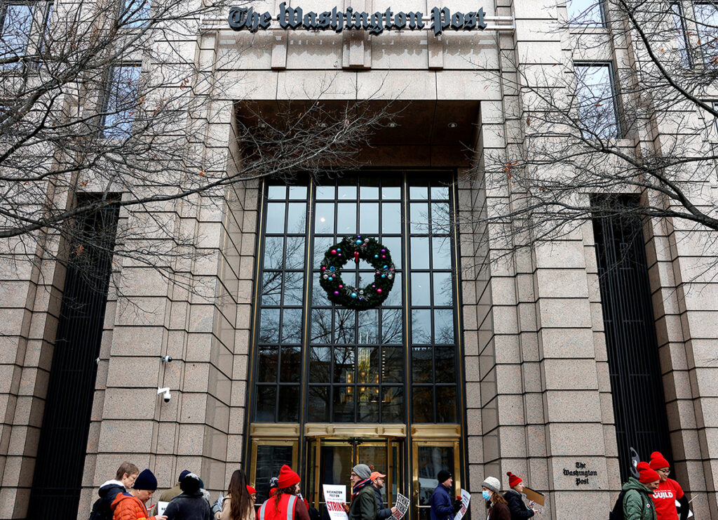 Washington Post staff walk a picket line at the start of a 24-hour strike amid prolonged contract talks outside The Washington Post building in Washington