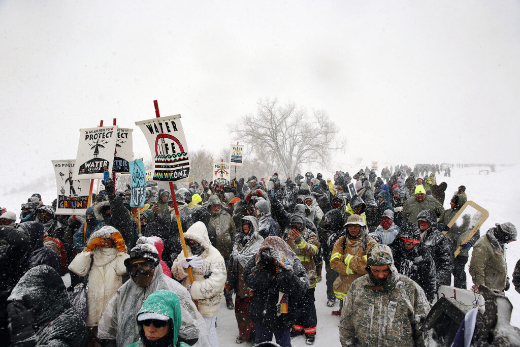 Veterans march with activists near Backwater Bridge just outside the Oceti Sakowin camp during a snow fall as "water protectors" continue to demonstrate against plans to pass the Dakota Access pipeline adjacent to the Standing Rock Indian Reservation