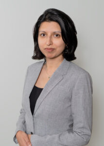 woman with grey jacket and short brown hair