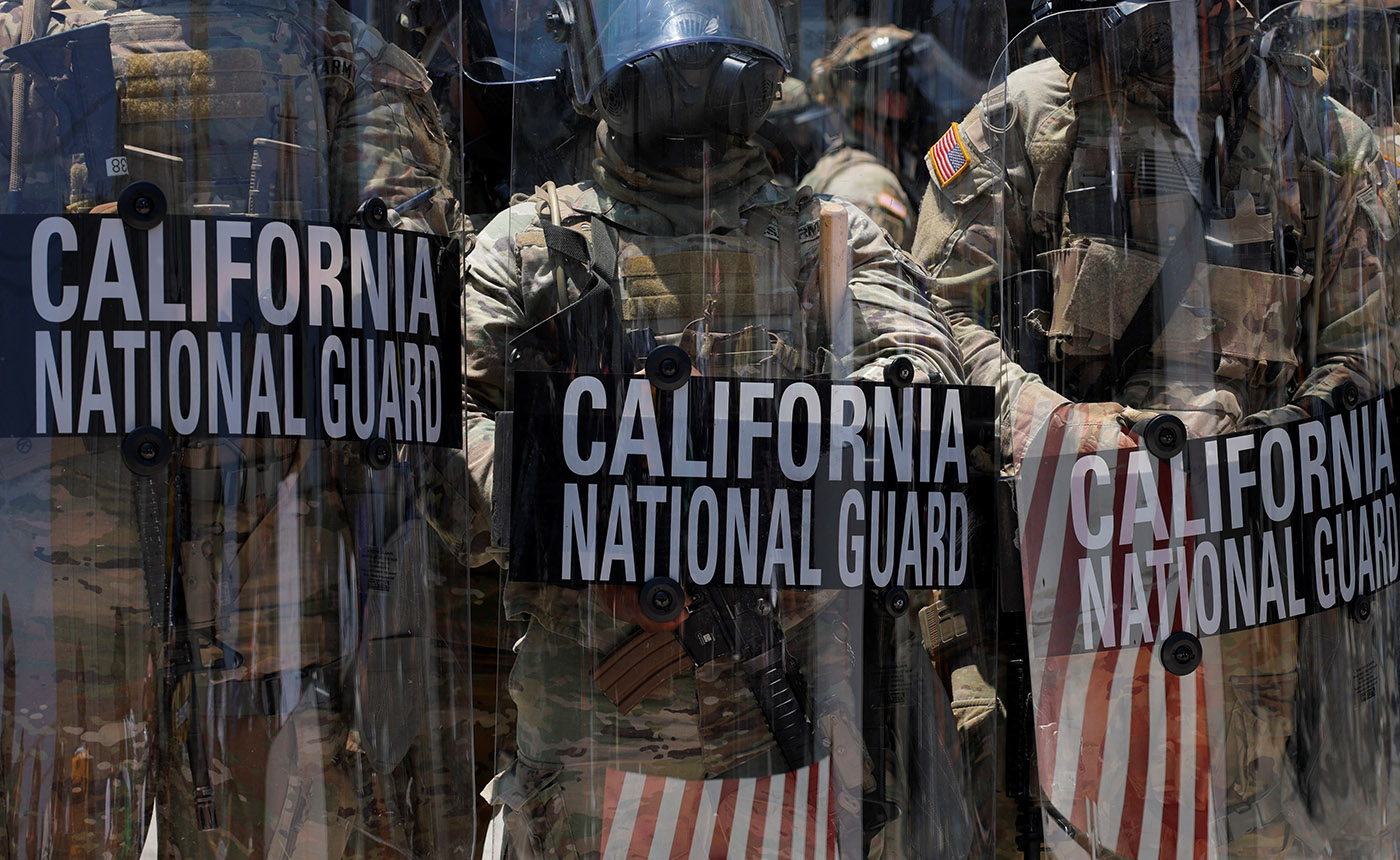 California National Guard troops stand outside the Edward R. Roybal federal building, in Los Angeles