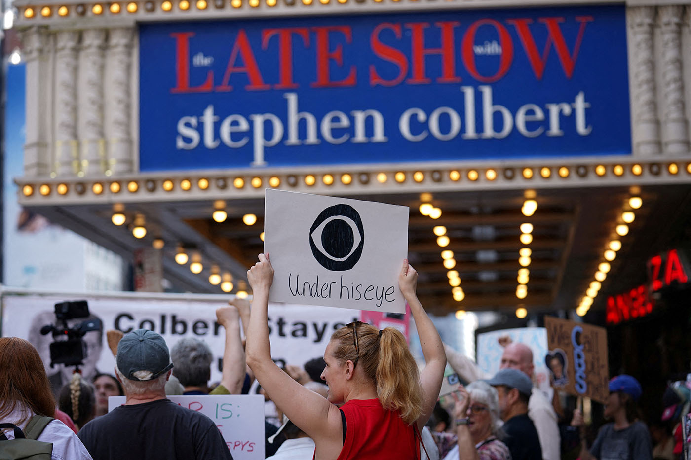 People protest after CBS/Paramount announced the cancellation of The Late Show with Stephen Colbert in New York