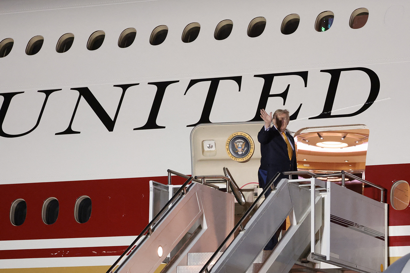 U.S. President Donald Trump boards the new, Qatari-gifted Air Force One after arriving on one of the older planes operating as Air Force One, to return to Washington, at RAF Mildenhall